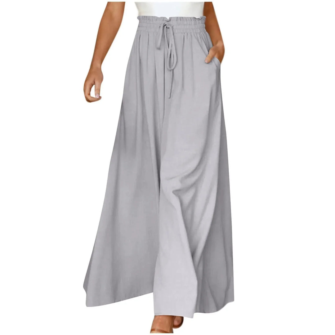 Woman wearing light gray wide-leg palazzo pants with drawstring waist and side pockets