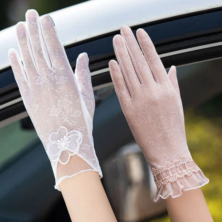 Pair of elegant women's lace gloves in white and light pink with floral and frilled details