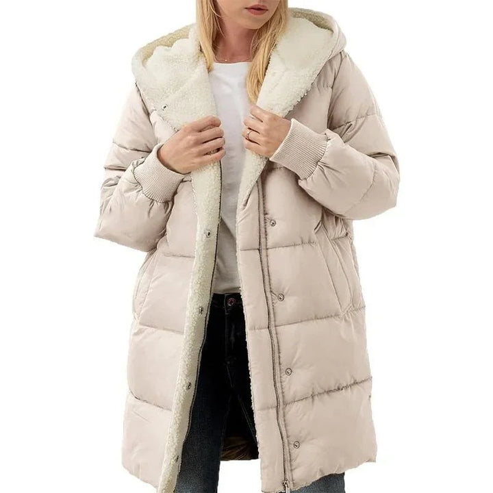 Woman wearing beige hooded puffer coat with sherpa lining and ribbed cuffs