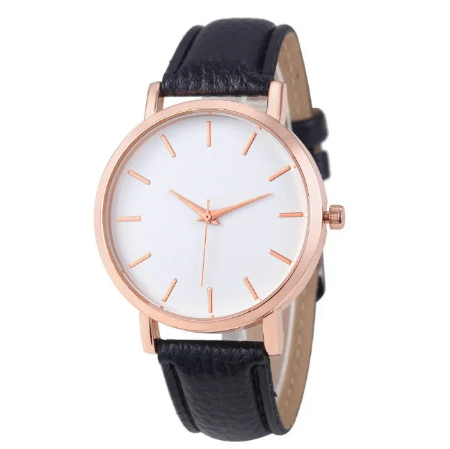 Minimalist wristwatch with rose gold case, white dial, and black leather strap