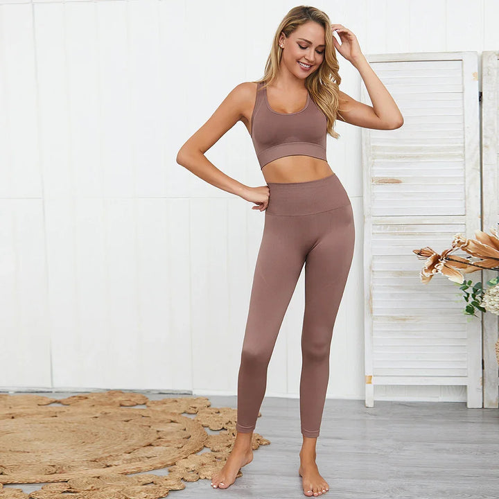 Woman modeling seamless brown yoga set with leggings and sports bra in bright room