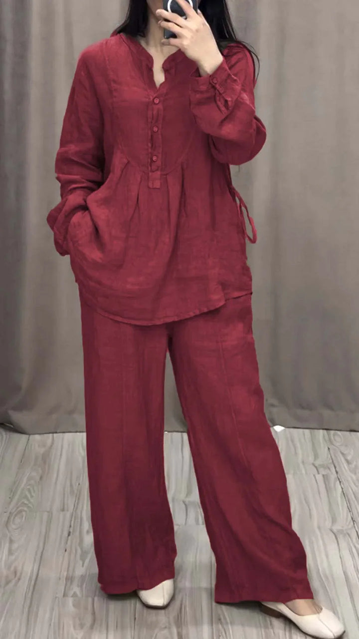 Woman wearing a loose red linen button-up top and matching wide-leg pants with white shoes