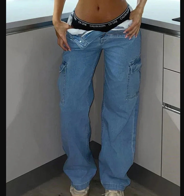 Person wearing loose blue cargo jeans and visible black Calvin Klein waistband underwear in modern kitchen