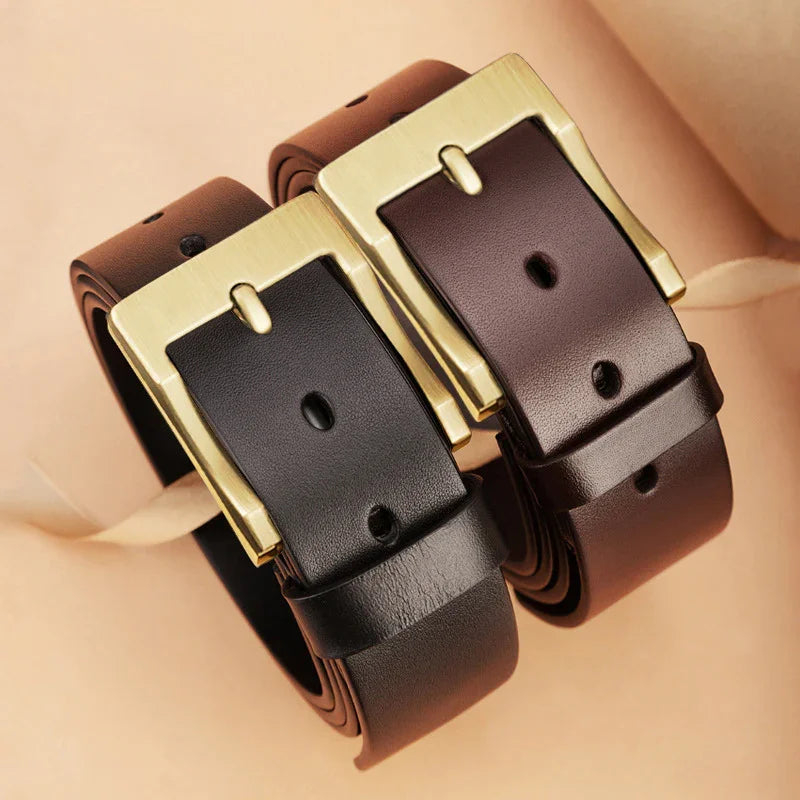 Two rolled leather belts with gold rectangular buckles in black and dark brown colors on beige background