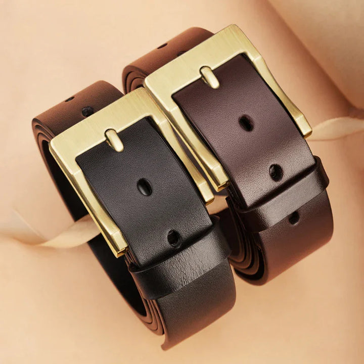 Two rolled leather belts with gold rectangular buckles in black and dark brown colors on beige background