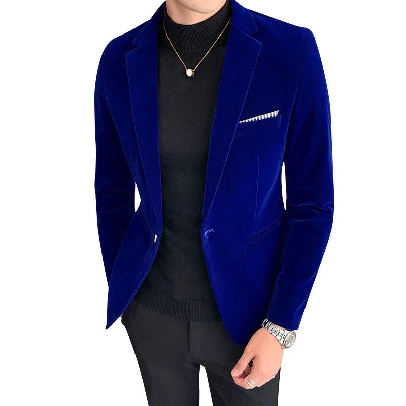 Man wearing a royal blue velvet blazer over a black turtleneck with a pocket square and silver watch