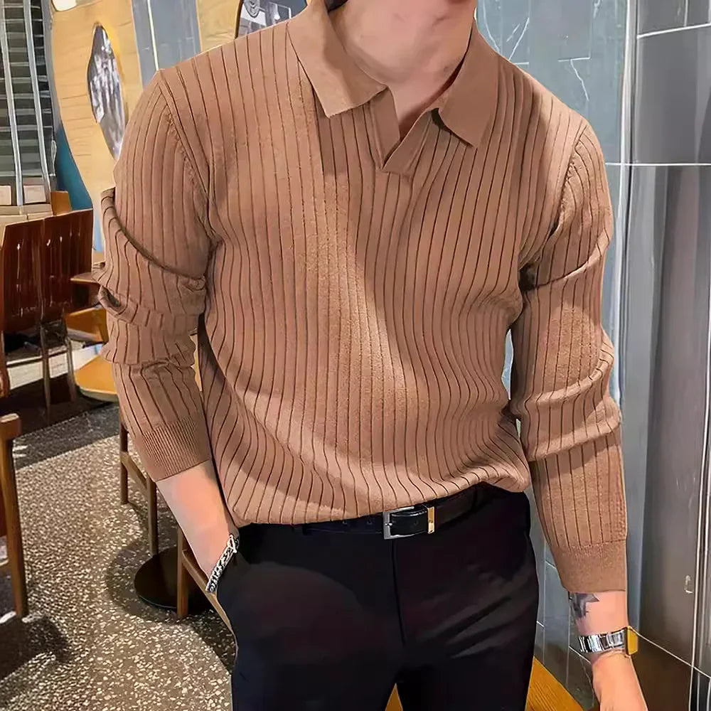 Man in brown ribbed knit polo sweater and black pants with accessories in modern cafe