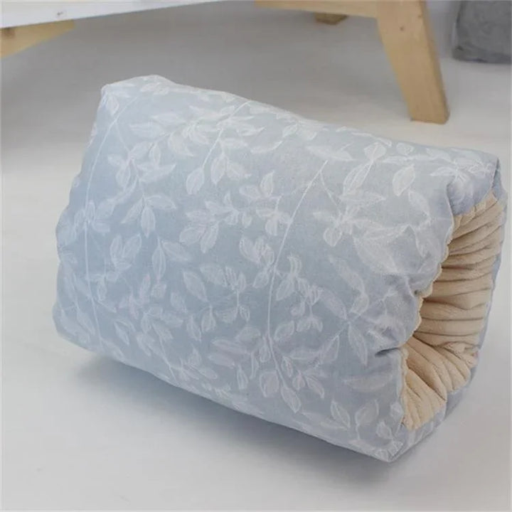 Soft blue pet bed with white leaf pattern and beige inner lining on white floor