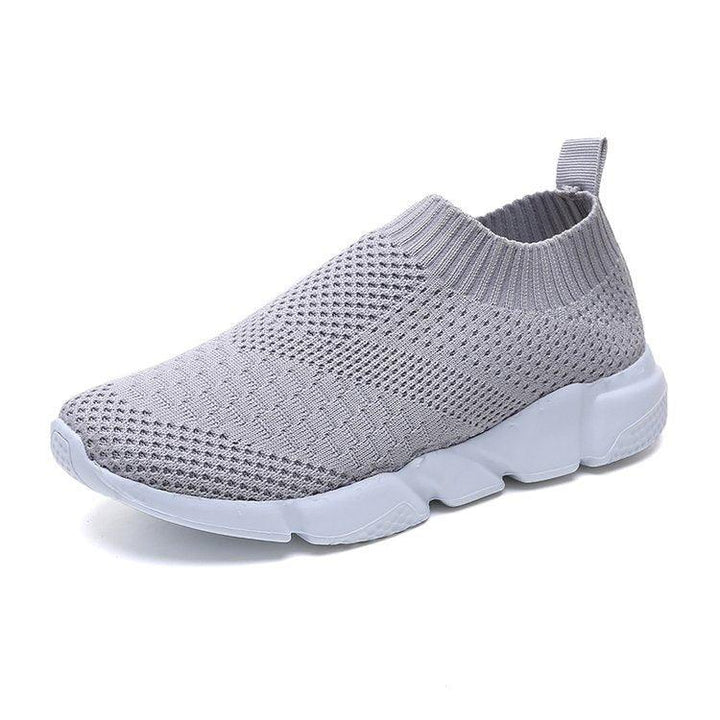 Light grey slip-on knit sneaker with white segmented sole and pull tab heel