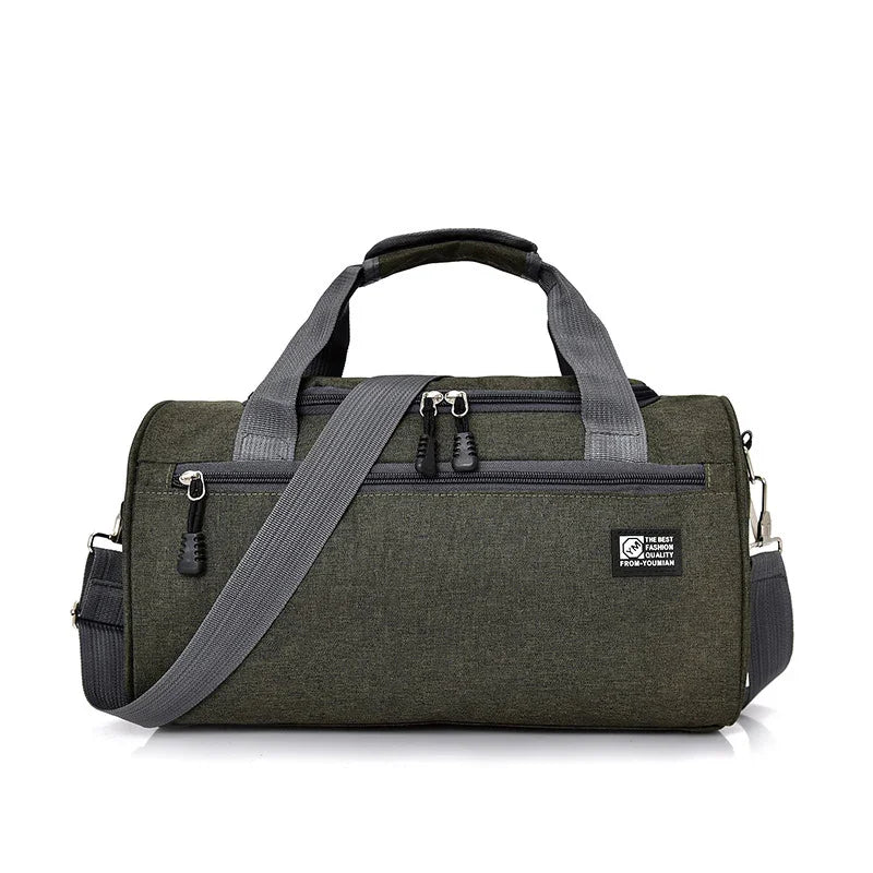 Dark green compact duffel bag with grey handles and adjustable shoulder strap on white background