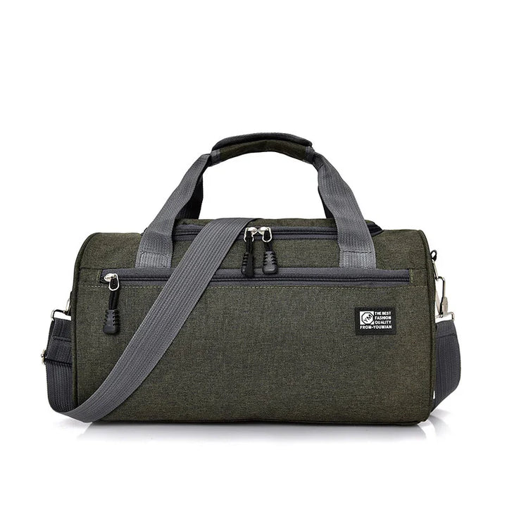 Dark green compact duffel bag with grey handles and adjustable shoulder strap on white background
