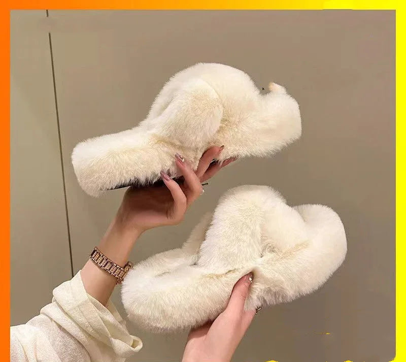 Pair of white fluffy slippers held by hands against beige background, cozy indoor footwear