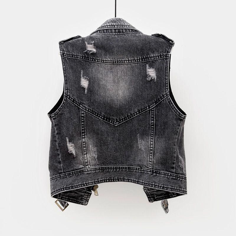 Back view of a distressed black denim vest hanging on a white background