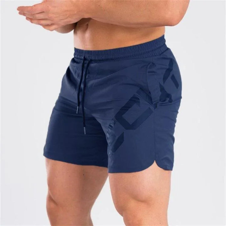 Man wearing navy blue athletic gym shorts with drawstring and geometric pattern