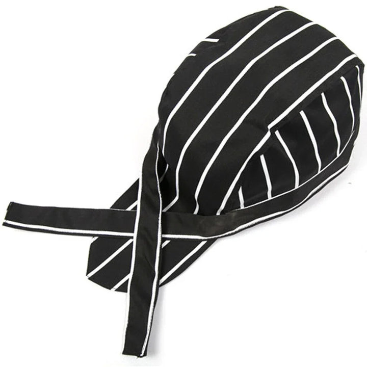 Black chef skull cap with white vertical stripes and attached ties on white background