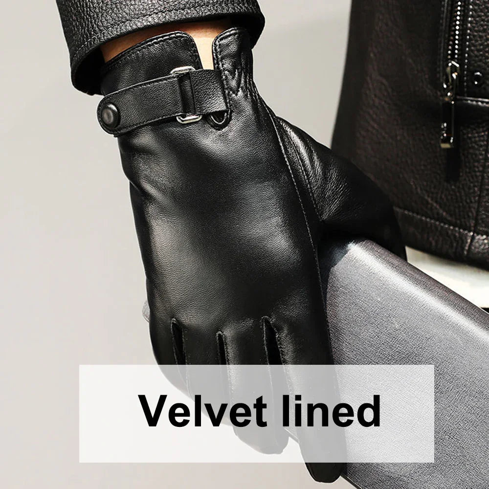 Close-up of a black leather glove with strap detail on wrist, holding a textured folder, velvet lined