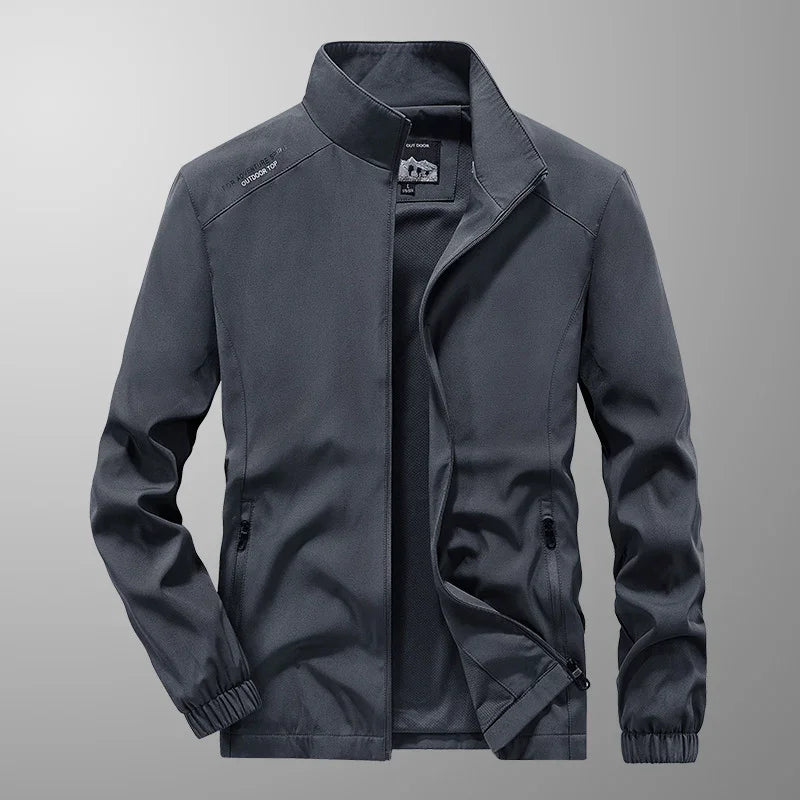 gray lightweight outdoor jacket with stand collar, zippered pockets, and elastic cuffs