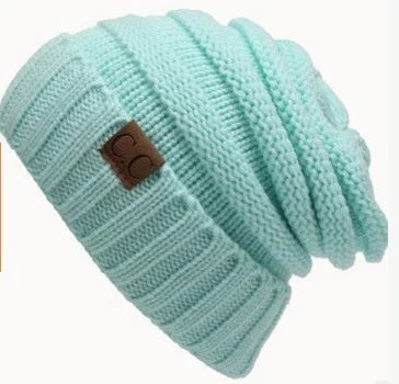 Mint green knitted beanie hat with a brown CC logo patch, cozy winter accessory