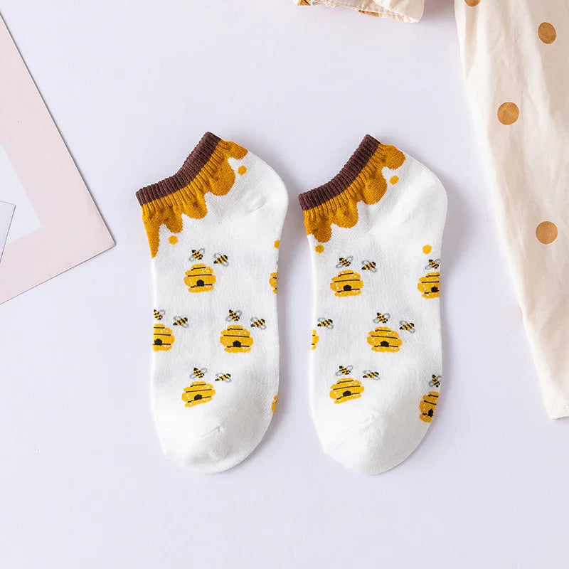 White ankle socks with yellow honeycomb and bee pattern, brown cuff detail on white background
