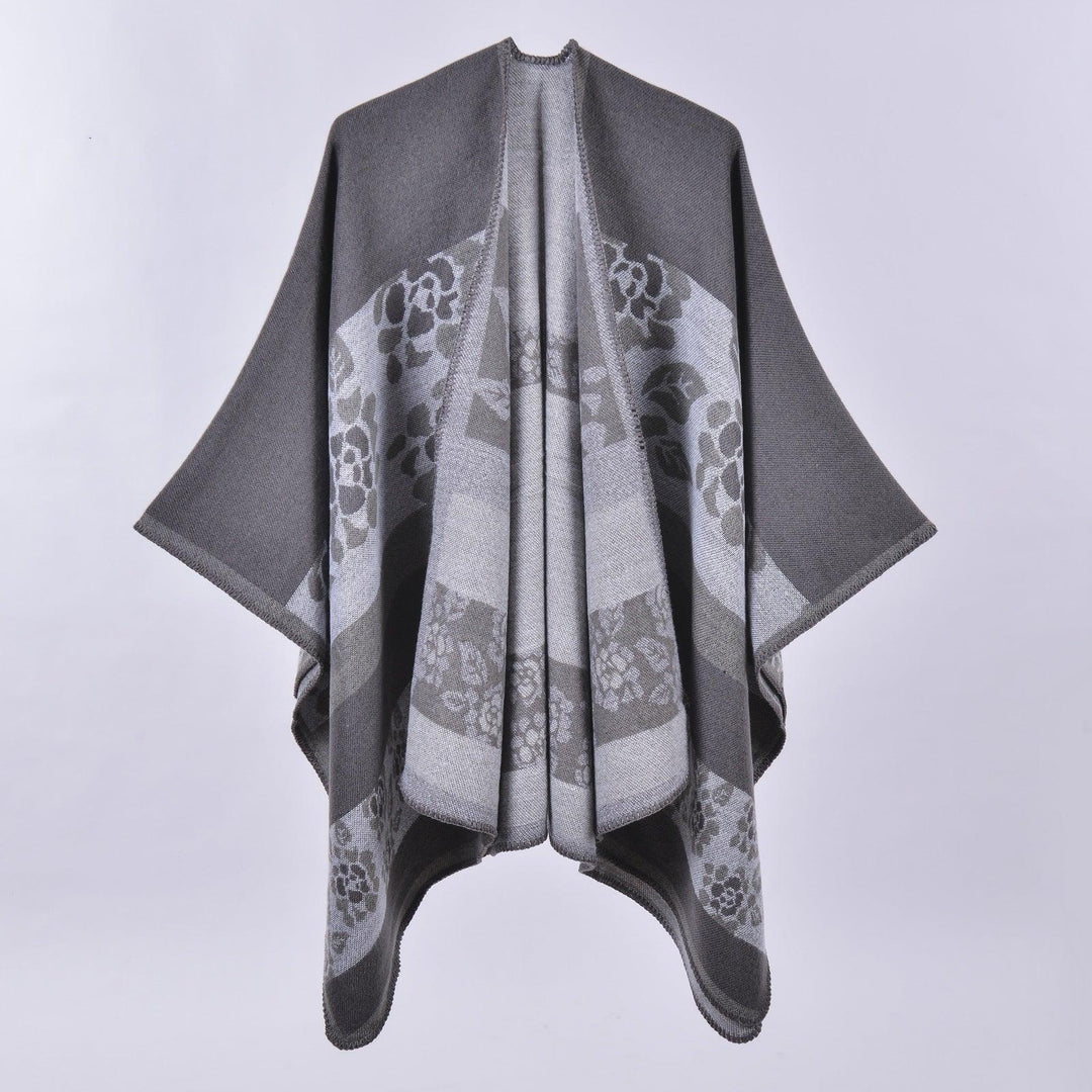 Gray shawl with floral pattern and wide sleeves on plain background