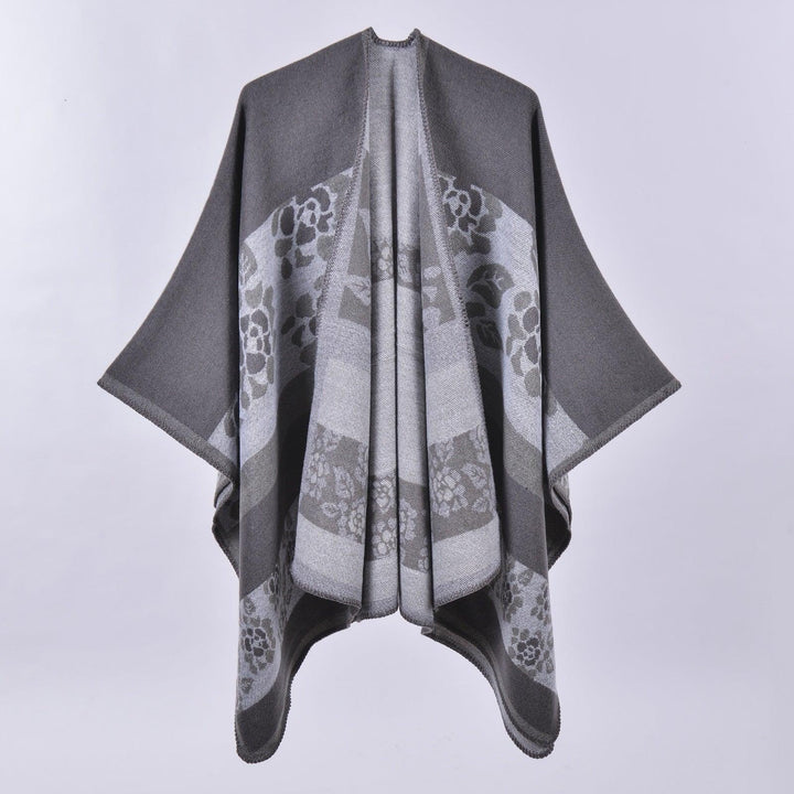 Gray shawl with floral pattern and wide sleeves on plain background