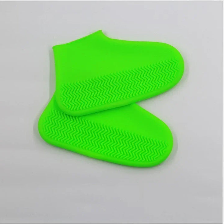Bright green silicone shoe covers with zigzag tread pattern on soles