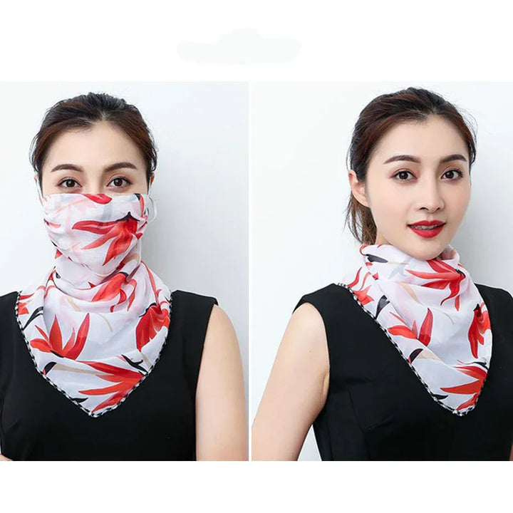 Woman wearing a white and red floral multifunctional scarf as face mask and neck cover with black sleeveless top
