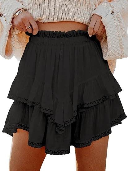 Woman wearing black layered ruffle shorts with lace trim and a beige knit sweater