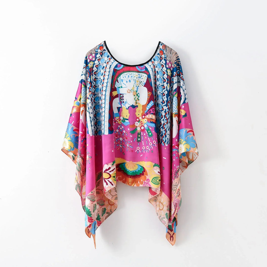 Colorful silk poncho with vibrant floral and abstract patterns on white background