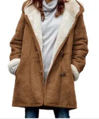 Woman wearing a brown shearling coat with white fleece lining and toggle buttons