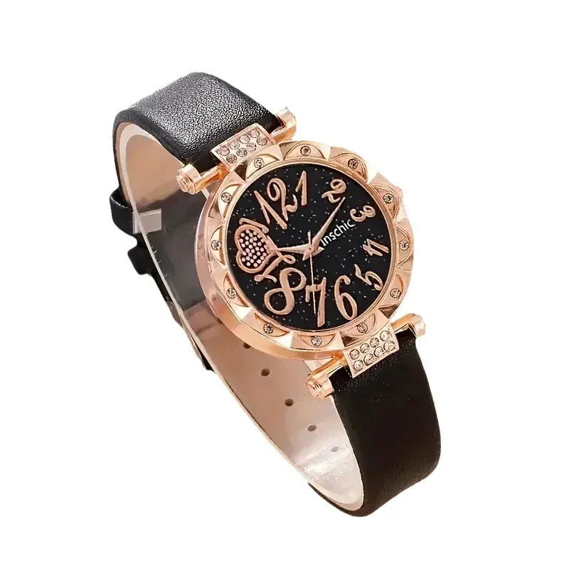 Elegant black leather strap wristwatch with rose gold case, decorative crystals, and stylized numbers