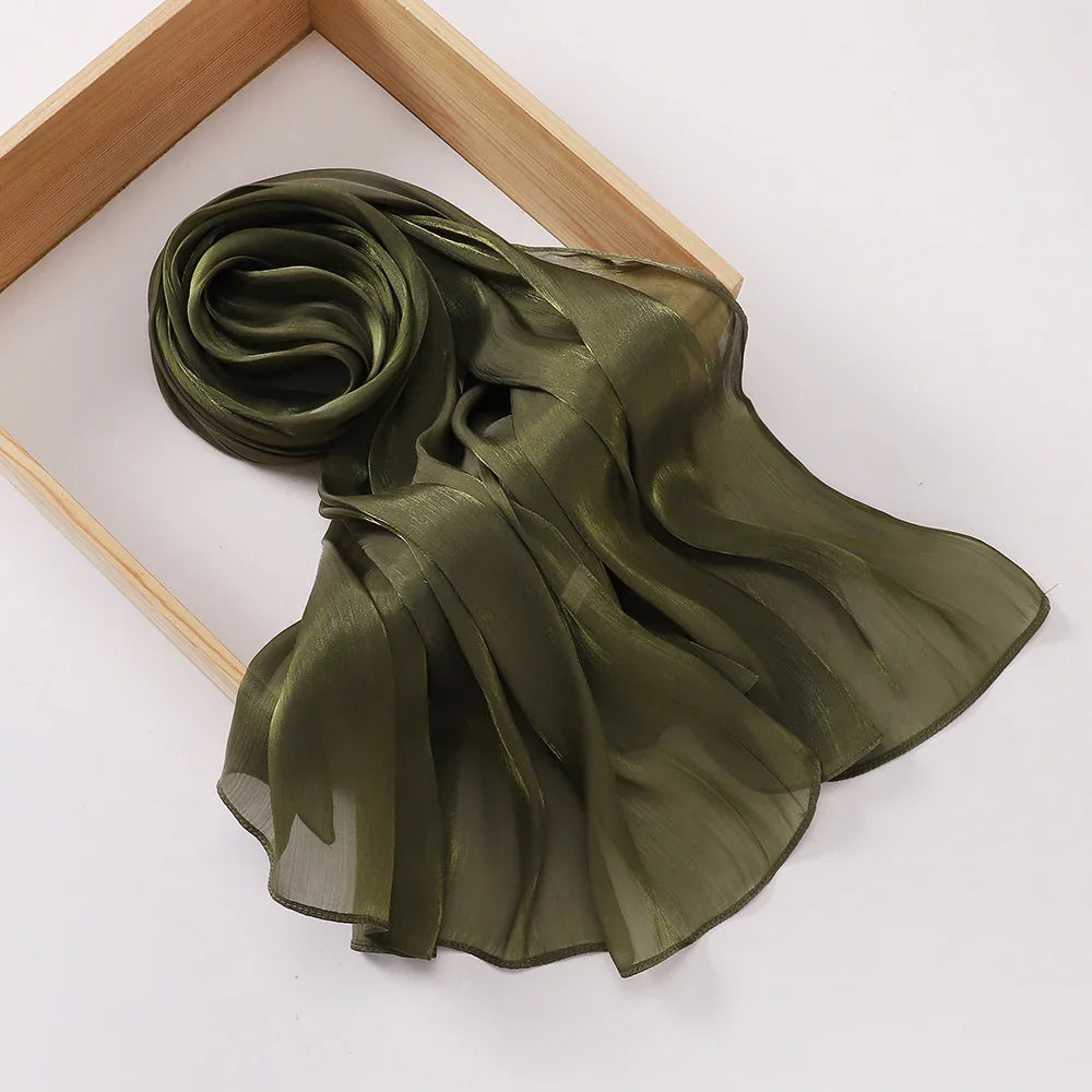 Olive green sheer chiffon scarf displayed on a wooden frame over a white background
