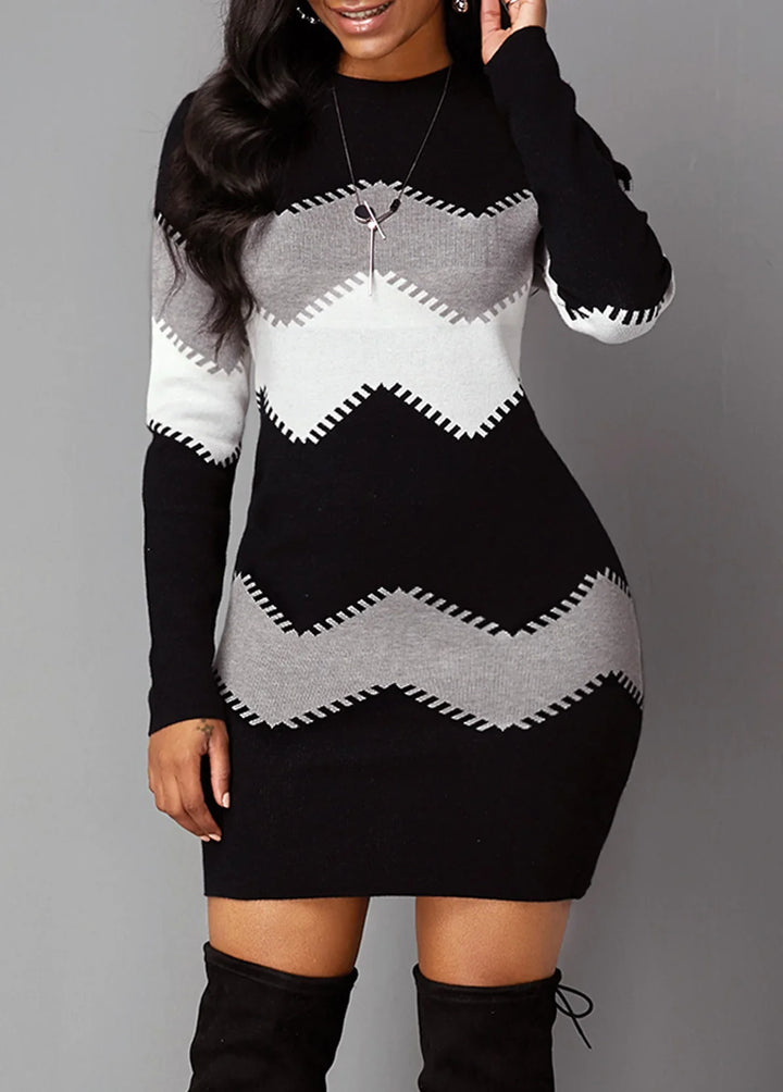 Woman wearing black, gray, and white zigzag pattern knit sweater dress with long sleeves and black thigh-high boots