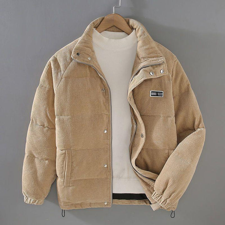 Beige corduroy puffer jacket with front zipper and snap buttons on gray background