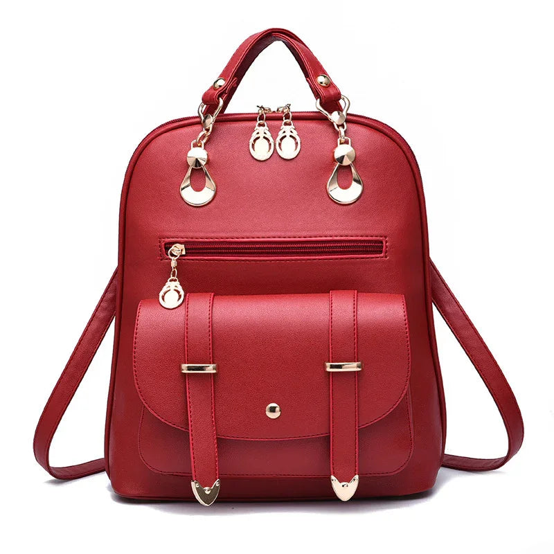 Red leather backpack with front pocket, gold-tone hardware, zipper, and top handle