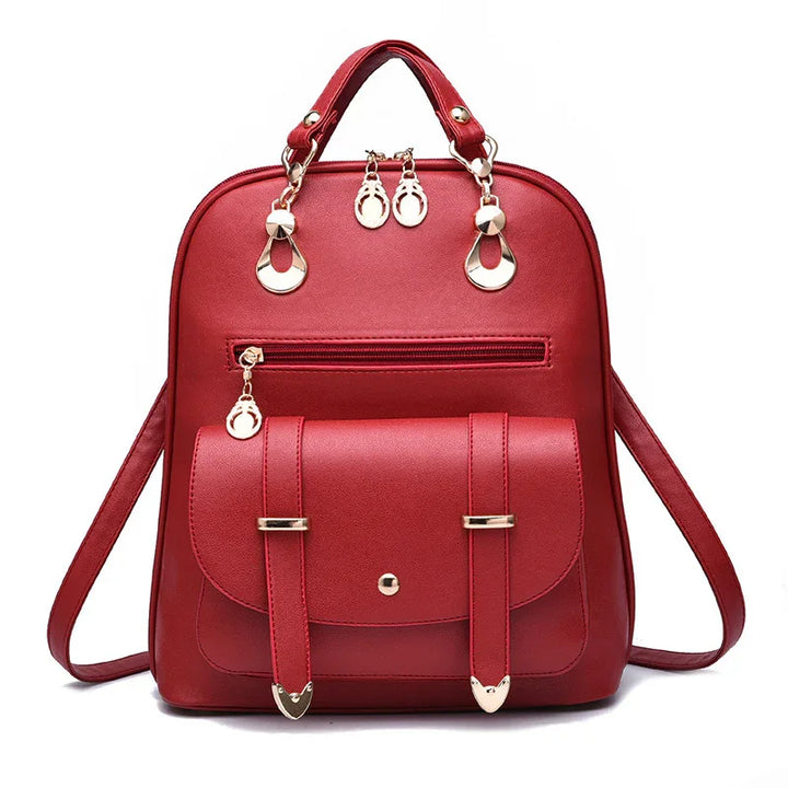Red leather backpack with front pocket, gold-tone hardware, zipper, and top handle