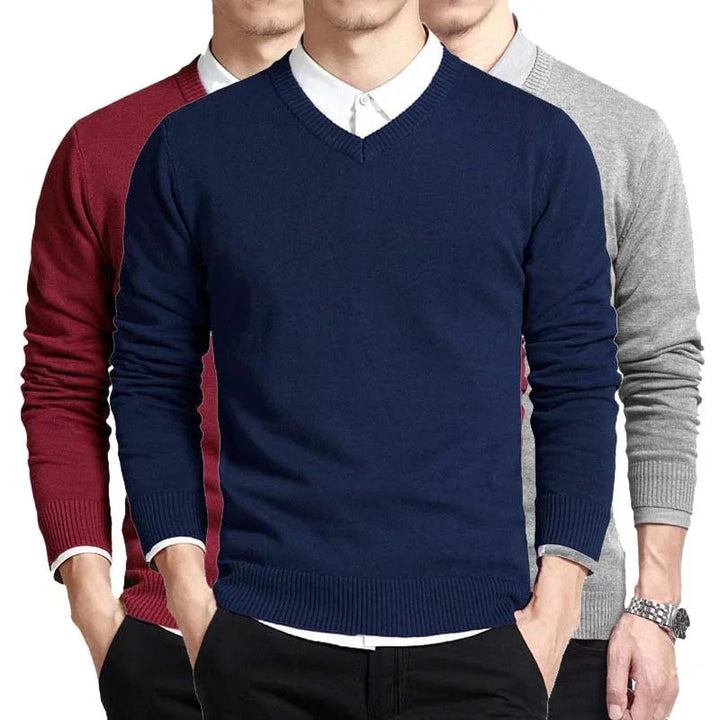 Men's V-neck sweaters in navy blue, burgundy, and gray, styled with white shirts and black pants
