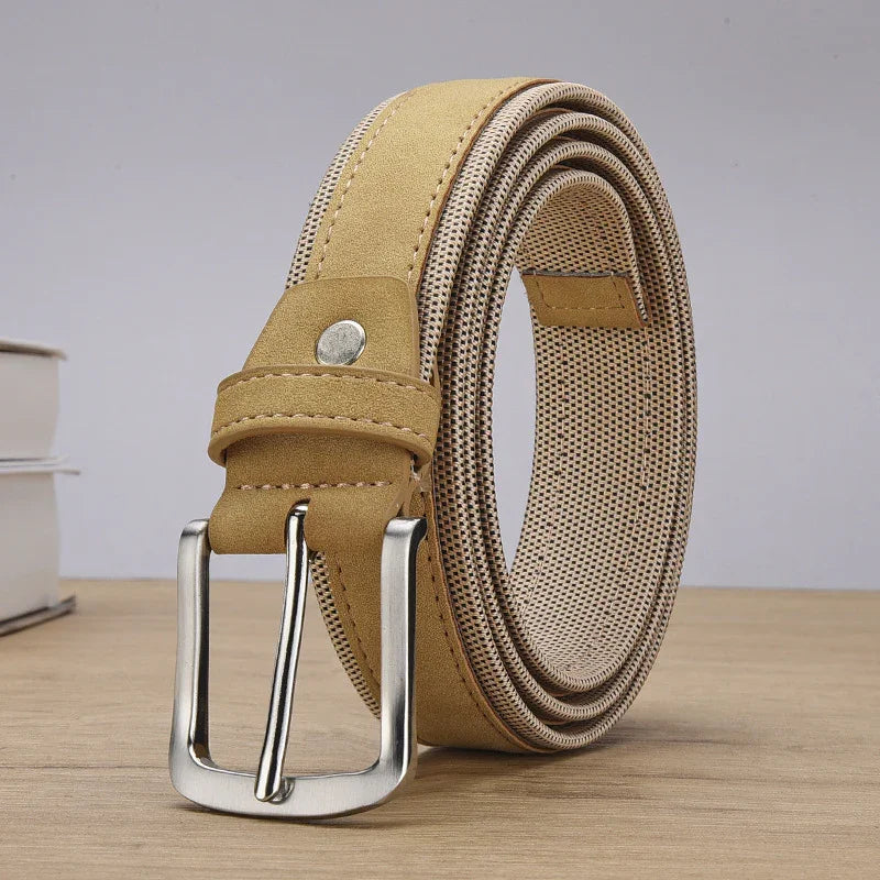 rolled tan leather belt with silver buckle on wooden surface