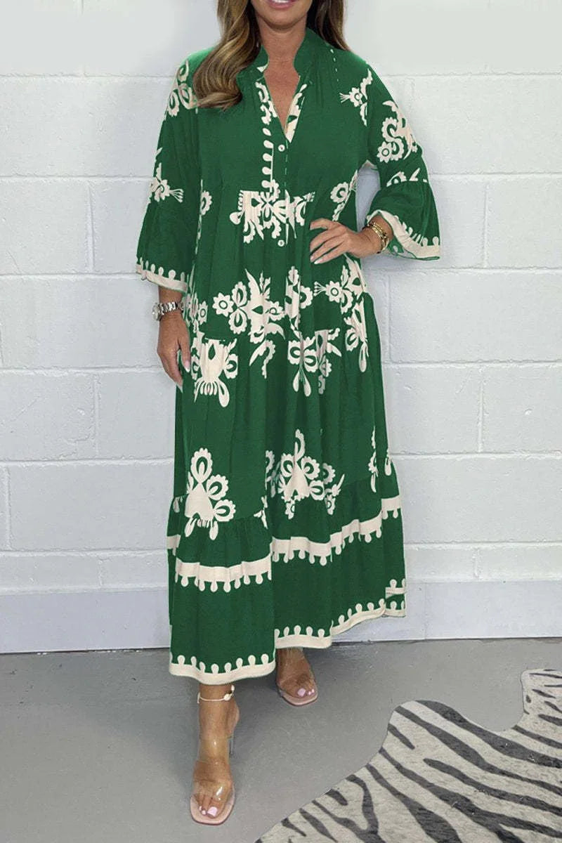 Woman wearing green and white patterned long sleeve maxi dress with ankle strap heels against white brick wall