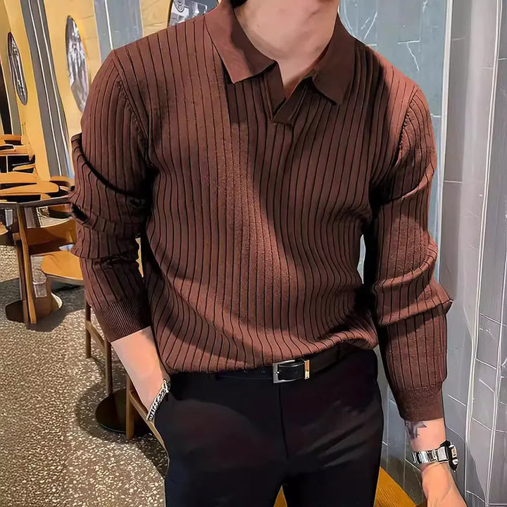 Man wearing brown ribbed knit polo sweater with black pants and silver watch indoors