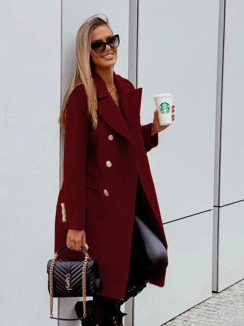 Stylish woman in burgundy coat, black sunglasses, holding Starbucks cup and black designer handbag