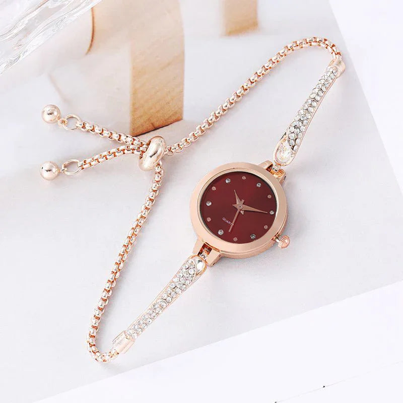 Elegant rose gold women's quartz watch with red dial and crystal-studded bracelet