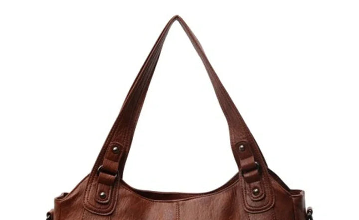 Brown leather shoulder bag with dual straps and silver-tone button details