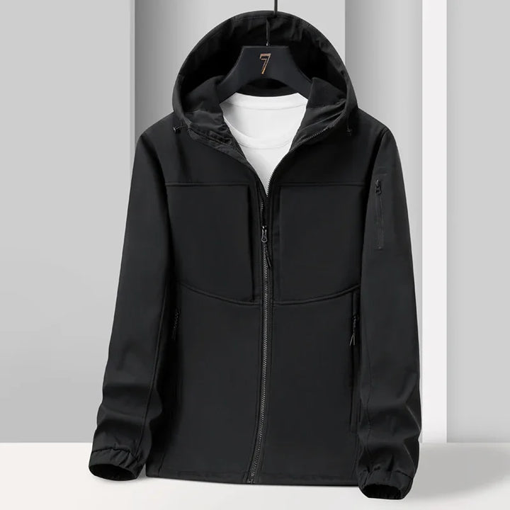 Black hooded softshell jacket with front zipper and white t-shirt inside on black hanger