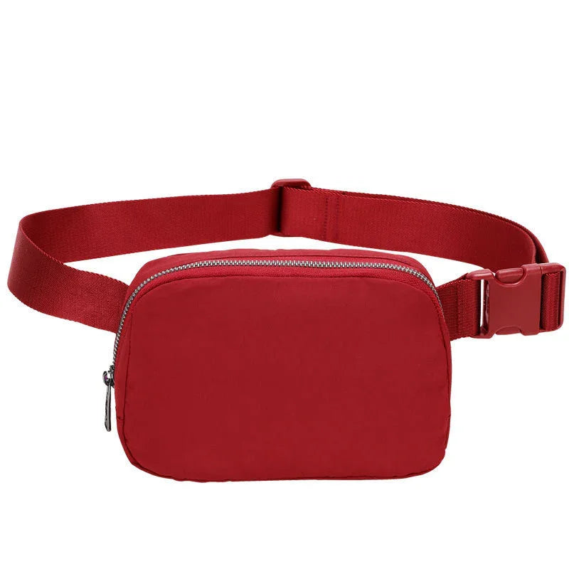 Red waist bag with zipper closure and adjustable strap on white background