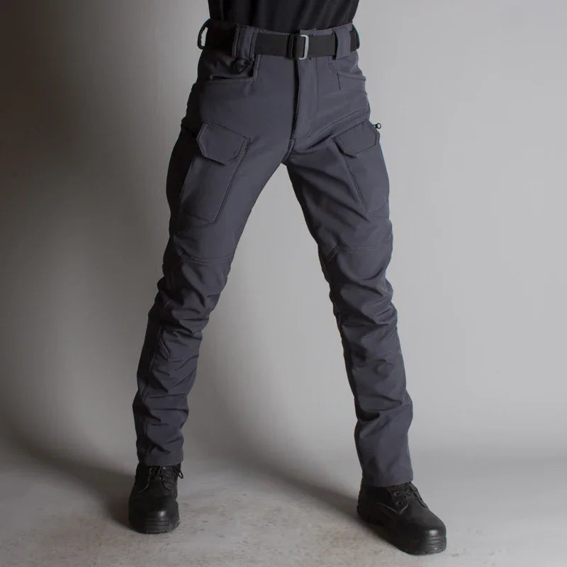 Front view of person wearing dark gray tactical cargo pants with black belt and black boots