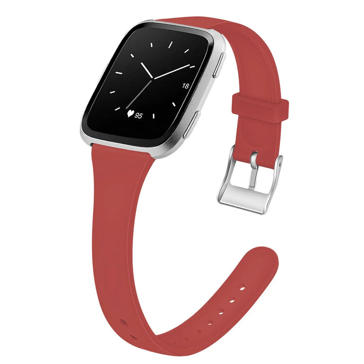 Smartwatch with silver frame and red silicone band showing analog clock and heart rate 95