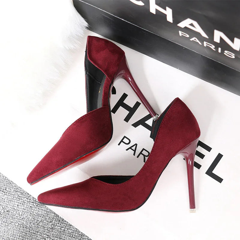 Elegant pair of burgundy suede high heels with pointed toes and shiny stiletto heels on Chanel box