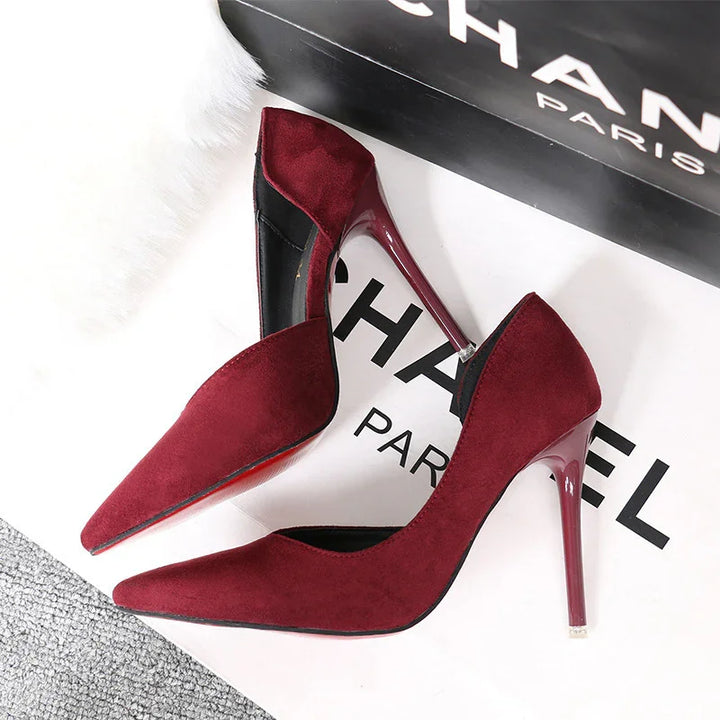Elegant pair of burgundy suede high heels with pointed toes and shiny stiletto heels on Chanel box
