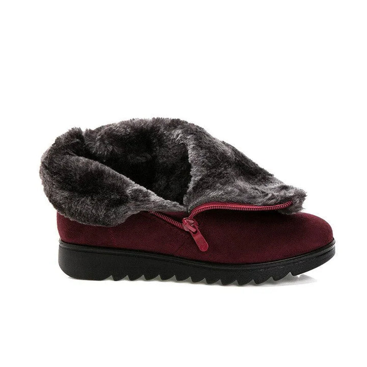 Burgundy suede winter shoe with black rubber sole and gray faux fur lining and zipper